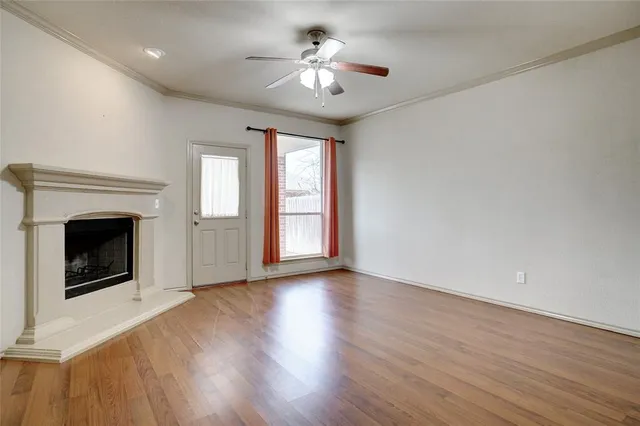a view of an empty room with a fireplace and a window