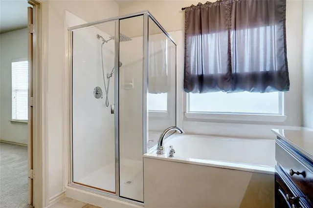 a bathroom with a tub and a shower