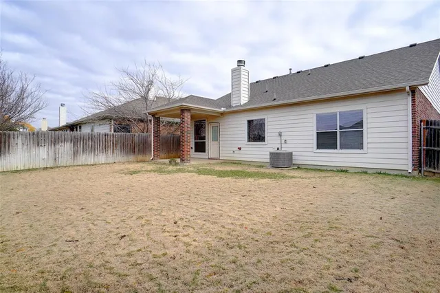 a backyard of a house with yard and outdoor seating