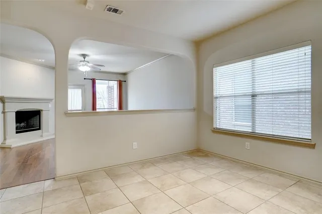 a view of an empty room with a fireplace and a window