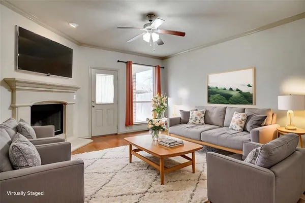 a living room with furniture a fireplace and a flat screen tv