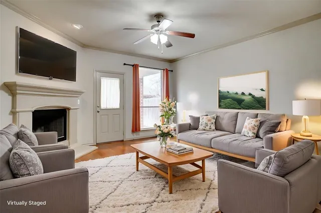 a living room with furniture a fireplace and a flat screen tv