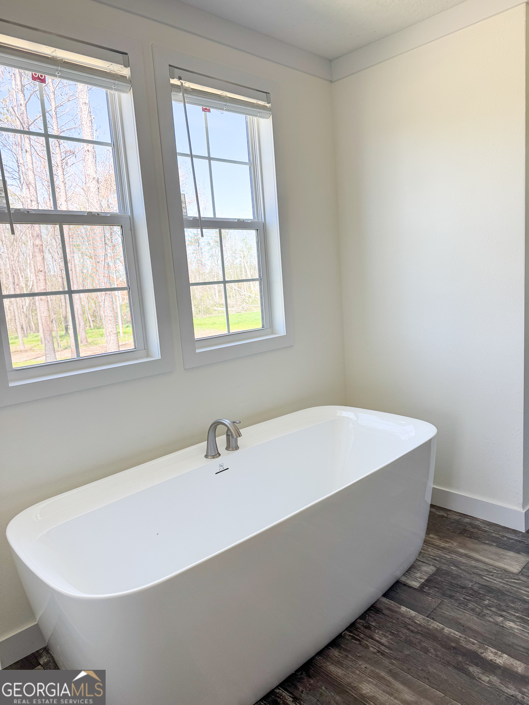 1505 West 4th St Extension Alma, GA 31510 - Photo 12 of 22 a white bath tub sitting in a bathroom