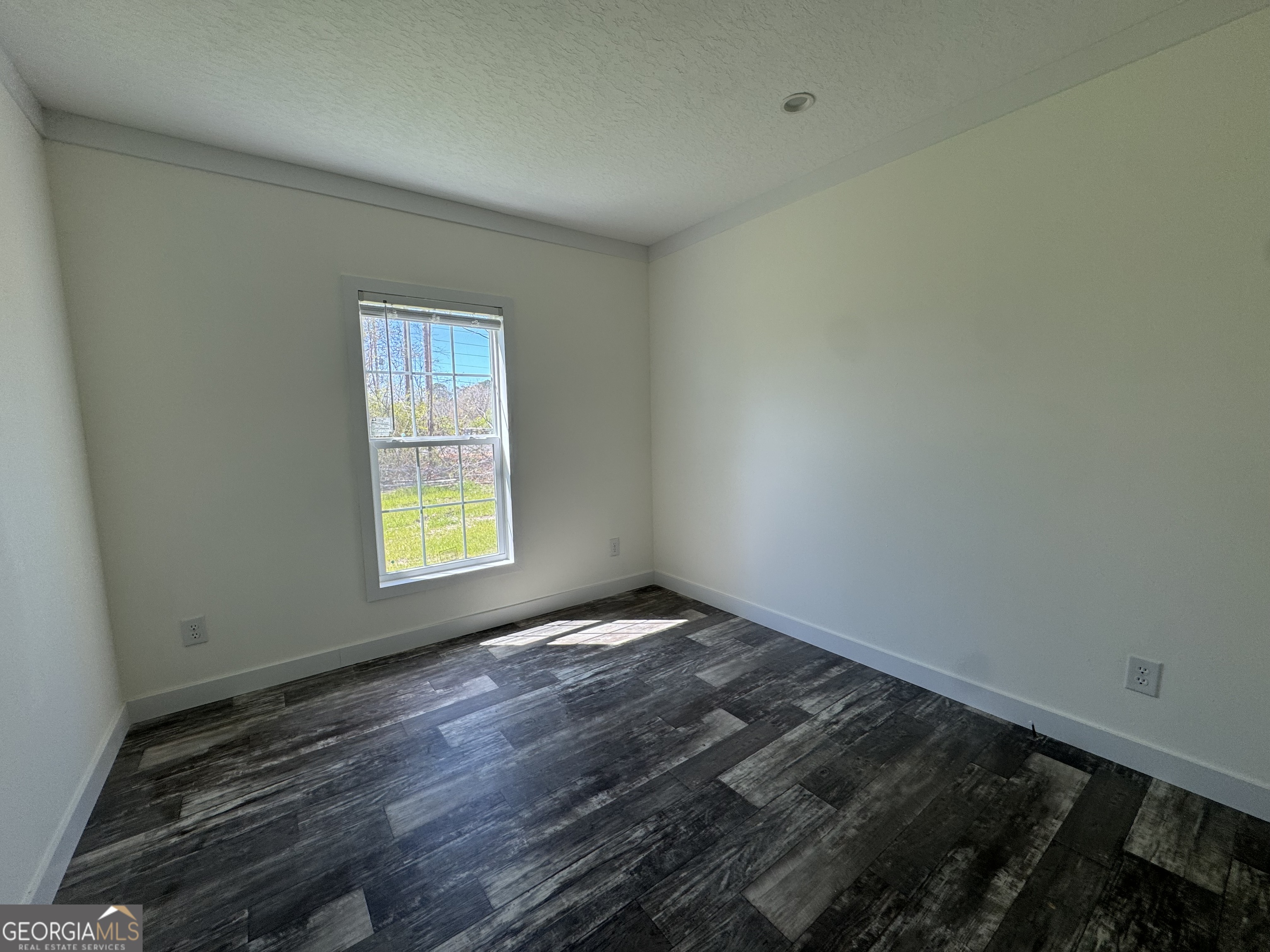 1505 West 4th St Extension Alma, GA 31510 - Photo 16 of 22 a view of an empty room and window