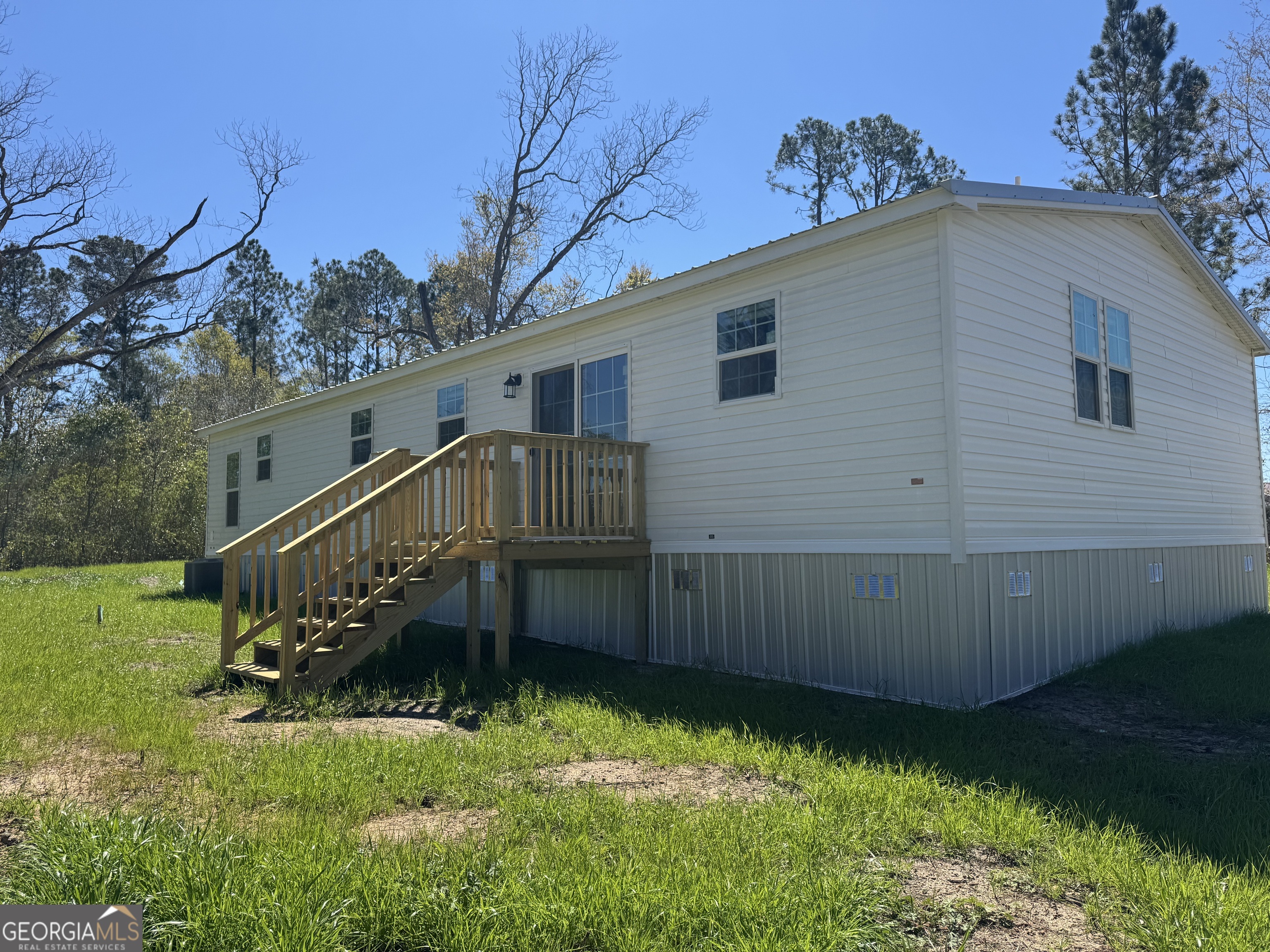 1505 West 4th St Extension Alma, GA 31510 - Photo 20 of 22 a view of backyard with deck and garden