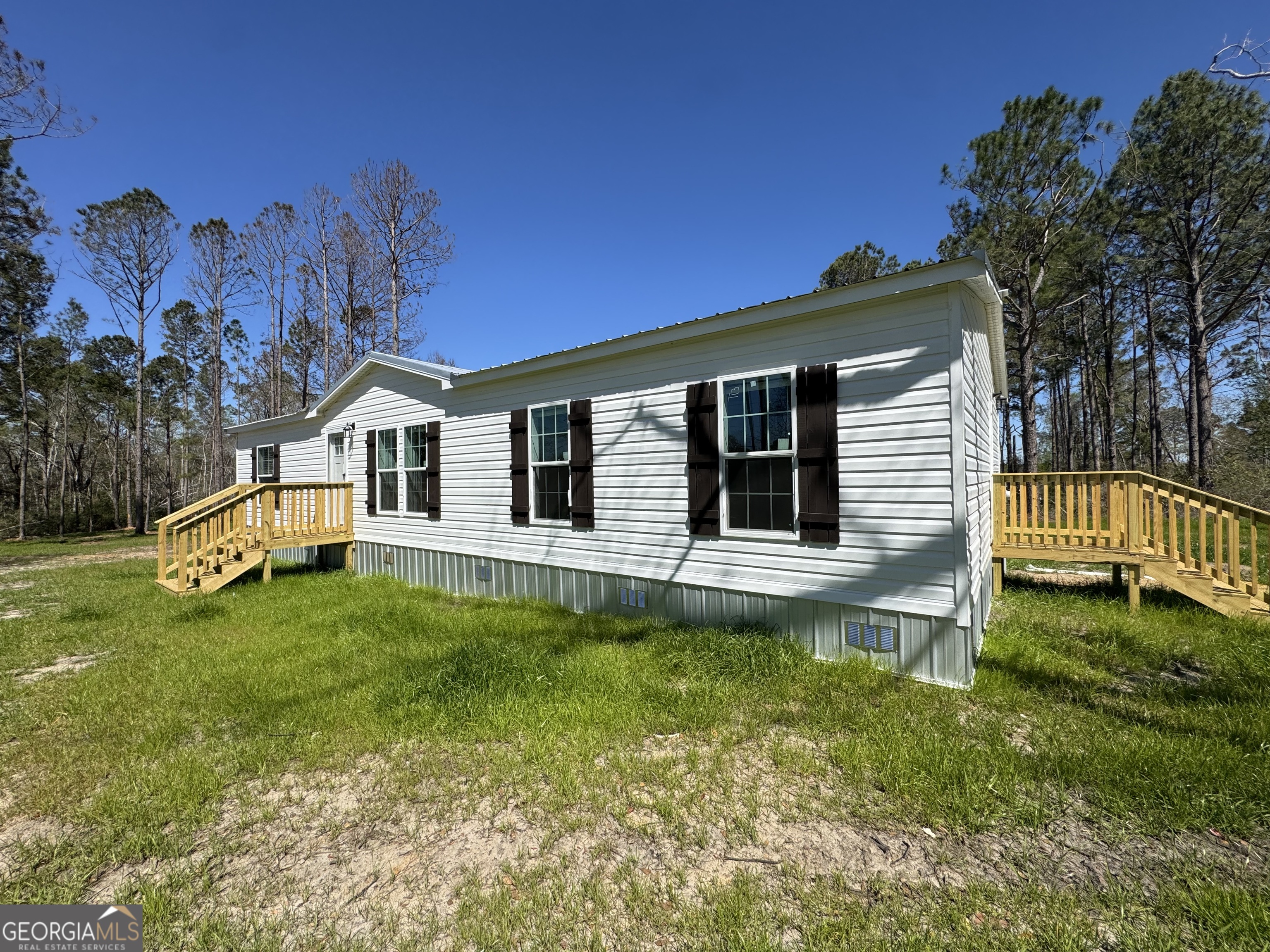 1505 West 4th St Extension Alma, GA 31510 - Photo 2 of 22 a house view with a garden space