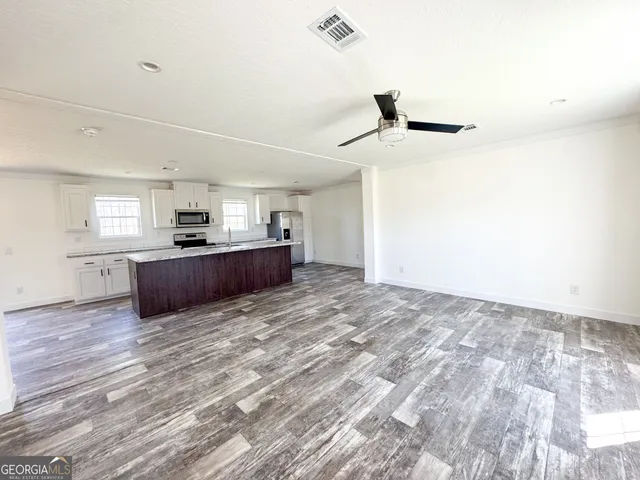 a view of a kitchen with a stove cabinets and wooden floor