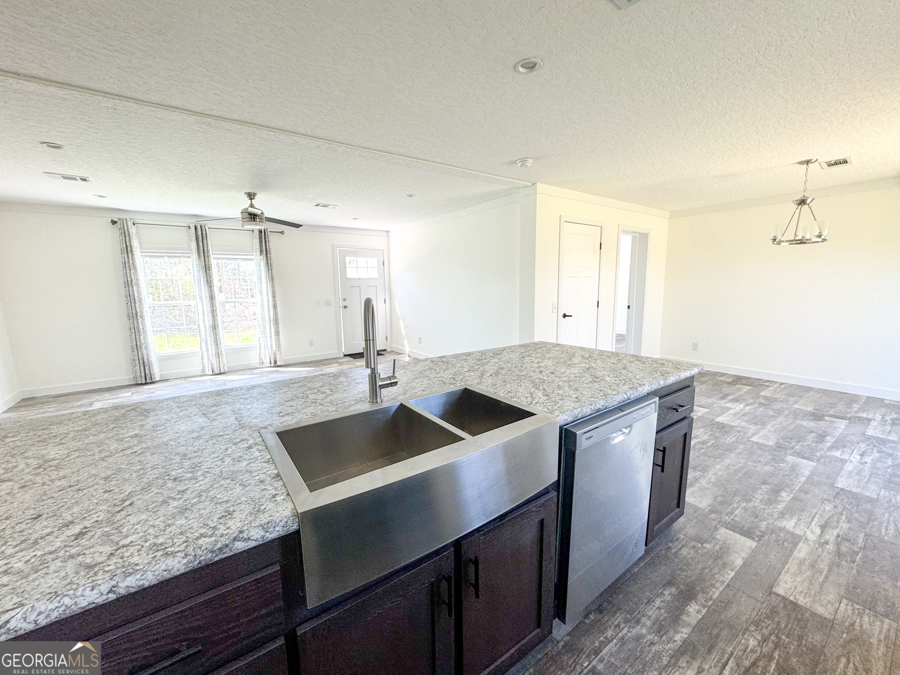 1505 West 4th St Extension Alma, GA 31510 - Photo 6 of 22 a kitchen with granite countertop a sink and a granite counter tops