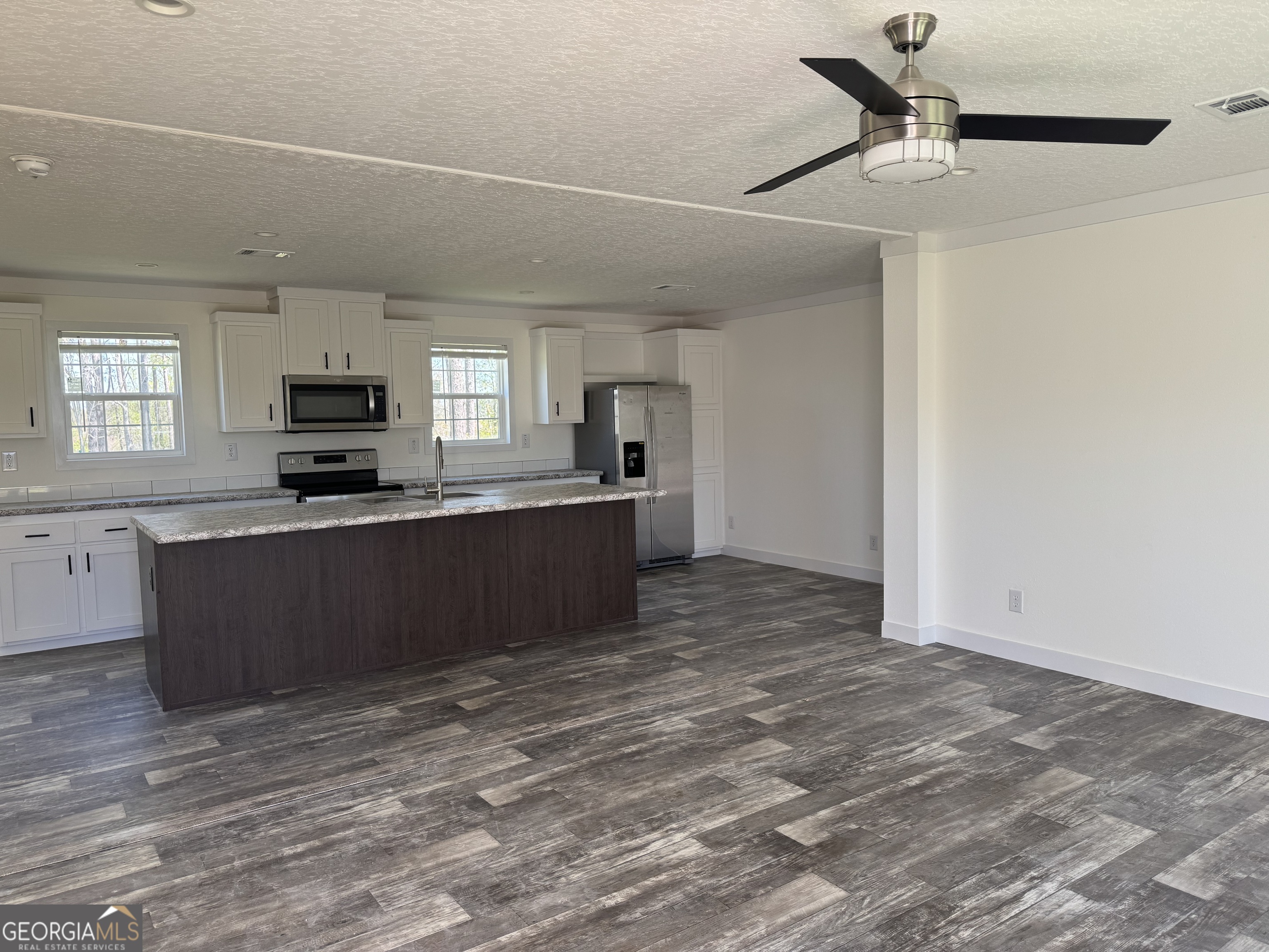 1505 West 4th St Extension Alma, GA 31510 - Photo 8 of 22 a kitchen with a refrigerator and a sink