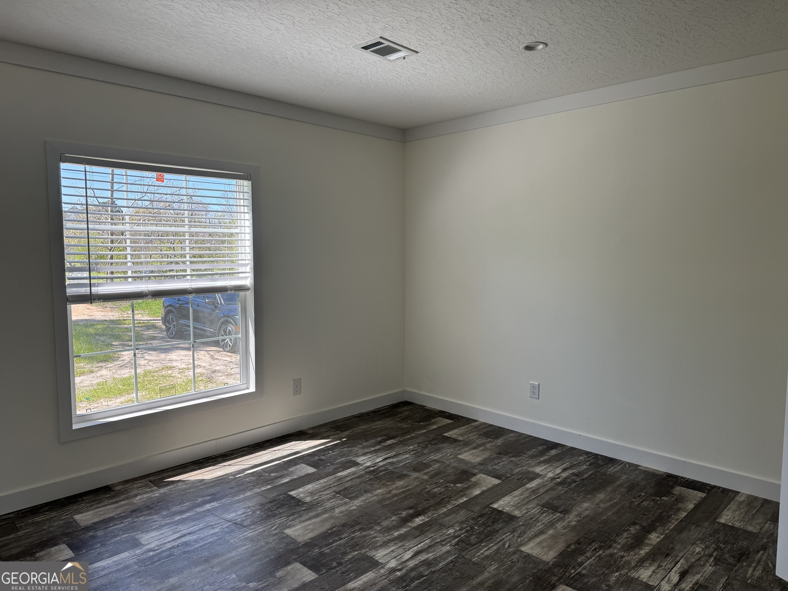 1505 West 4th St Extension Alma, GA 31510 - Photo 9 of 22 a view of an empty room and window