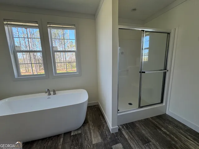 a bathroom with a bathtub and shower