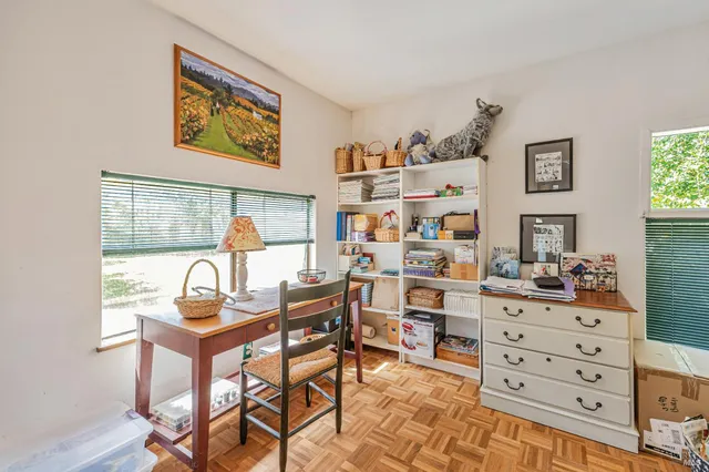 a bedroom with a bed and a book shelf