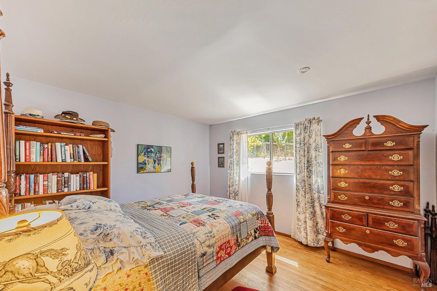 3590 Burnside Road Sebastopol, CA 95472 - Photo 27 of 69 a bedroom with a bed and a book shelf