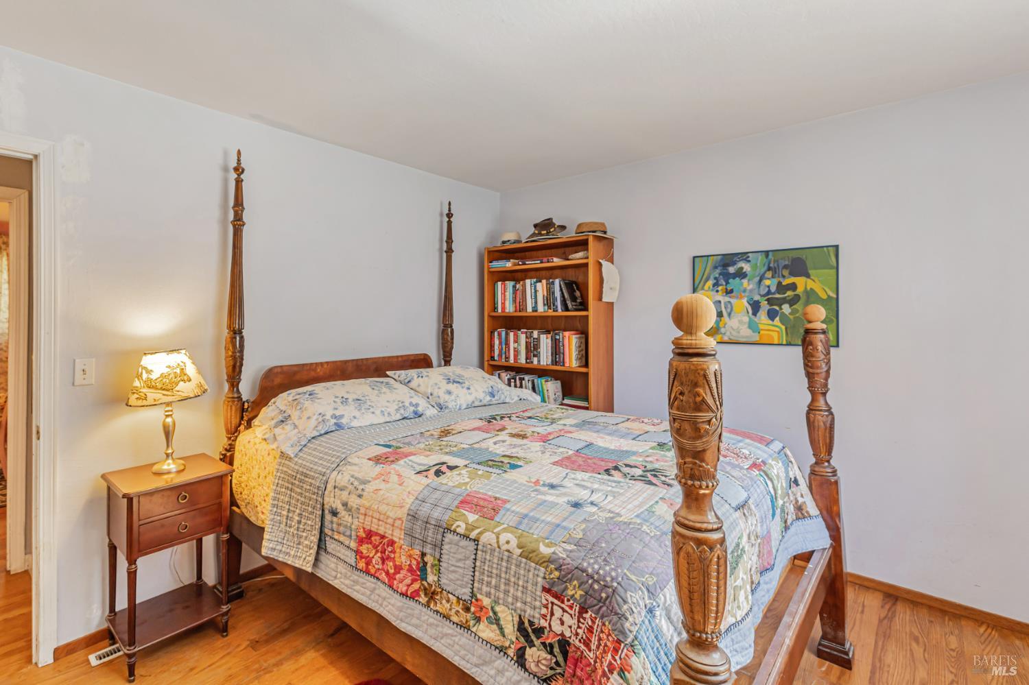 3590 Burnside Road Sebastopol, CA 95472 - Photo 28 of 69 a bedroom with a bed and wooden floor