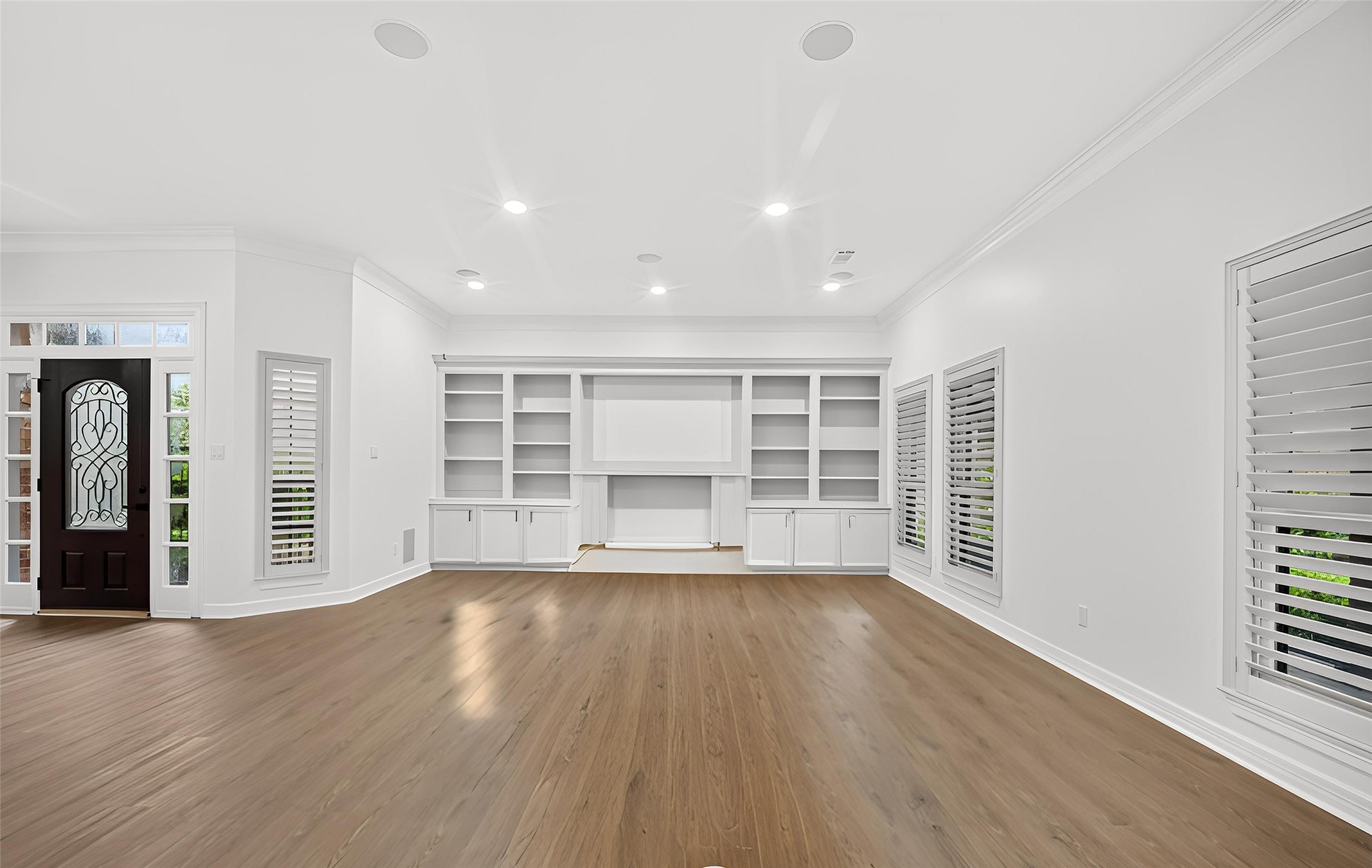 4415 Country Club View Baytown, TX 77521 - Photo 12 of 50 Spacious living room featuring extensive built-in shelving and ample storage solutions.