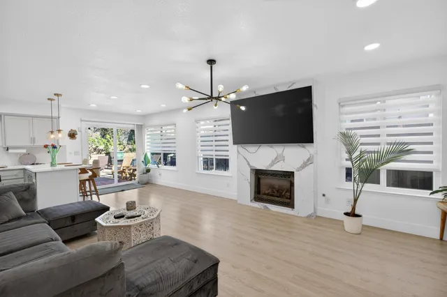 a living room with furniture a fireplace and a flat screen tv