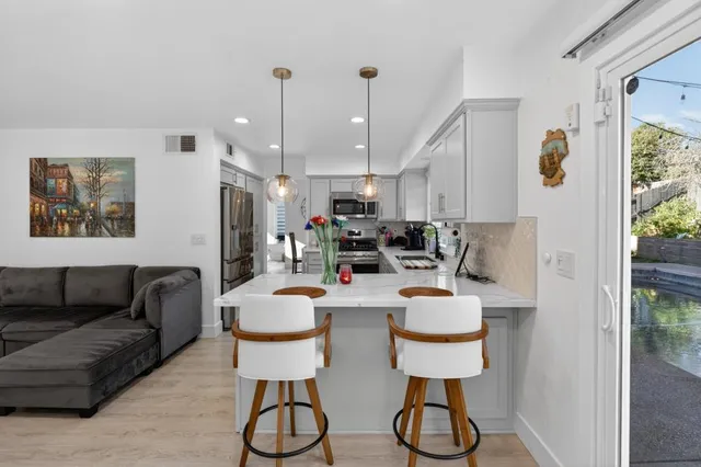 a kitchen with stainless steel appliances granite countertop a stove and a refrigerator