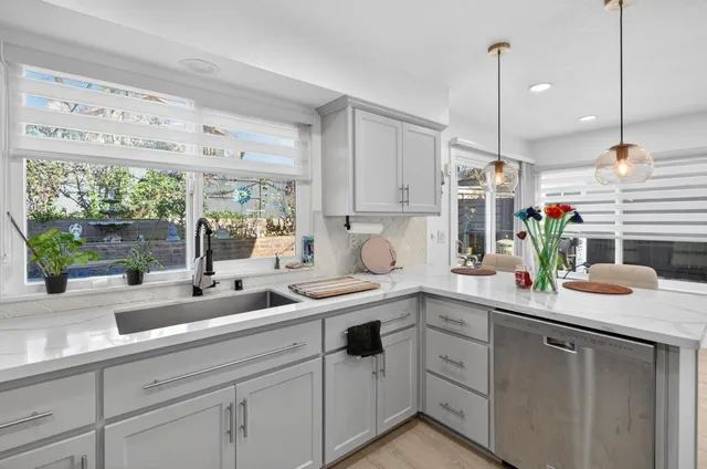 a kitchen with a sink window and cabinets