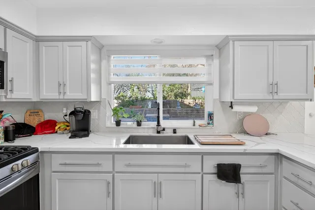 a kitchen with sink cabinets and utility