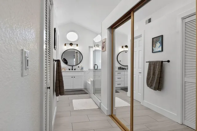 a en suite bathroom with a granite countertop shower