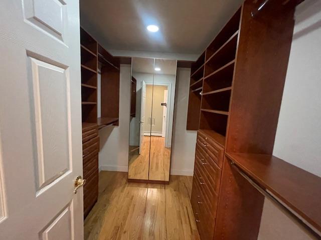 Undisclosed Address Stony Brook, NY 11790 - Photo 16 of 26 a view of hallway with stairs and wooden floor