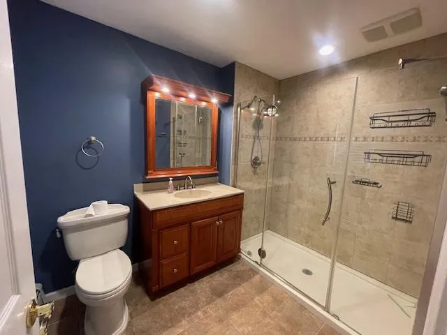 a bathroom with a toilet sink and shower