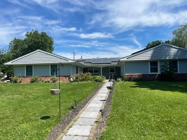 a front view of a house with garden