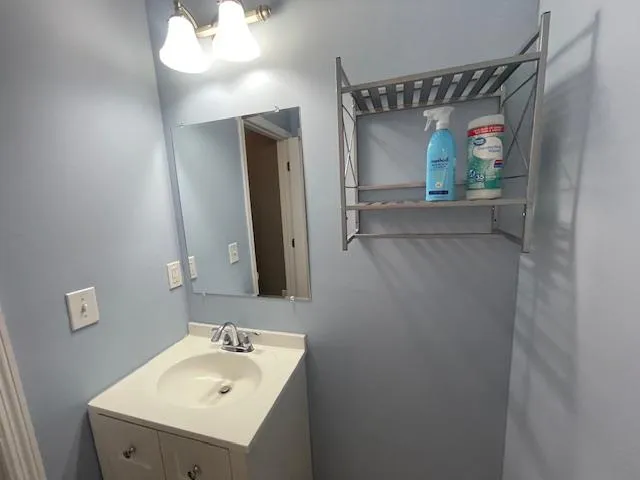 a bathroom with a sink and mirror