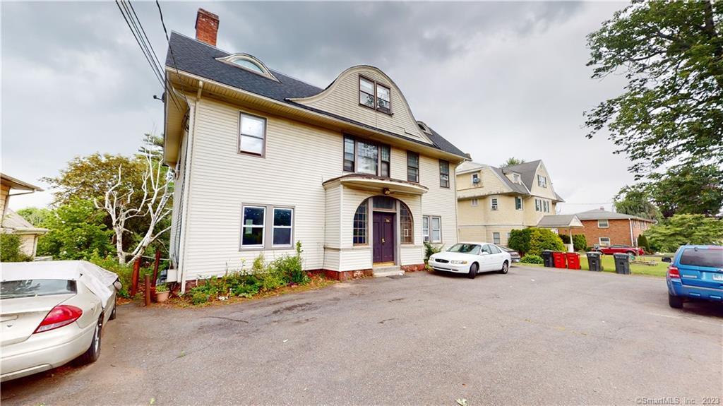 a view of a cars park in front of a house