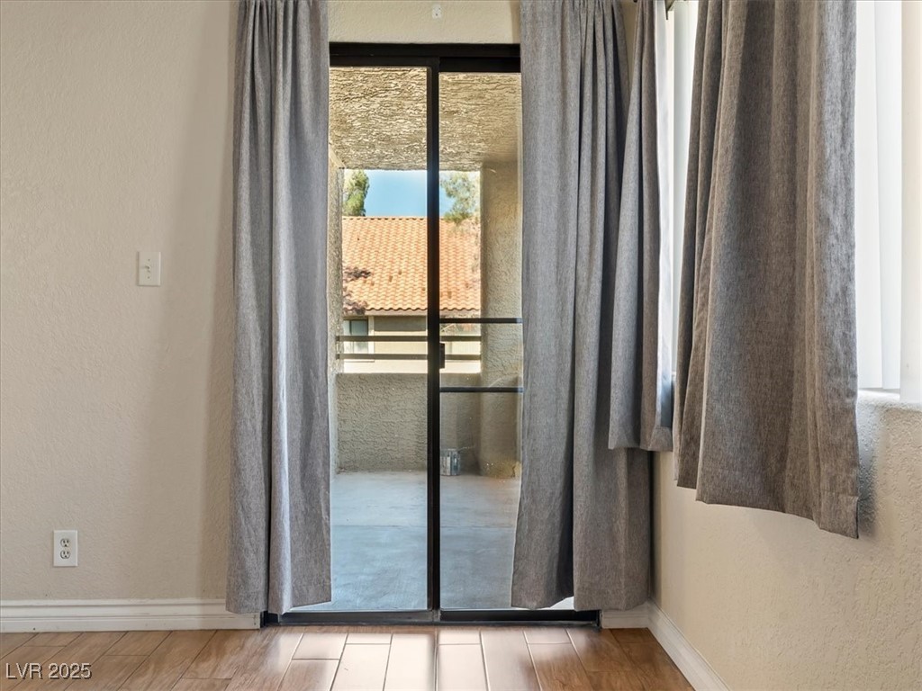 5052 South Rainbow Boulevard, Unit 201 Las Vegas, NV 89118 - Photo 20 of 24 Doorway with a textured wall and wood finished floors