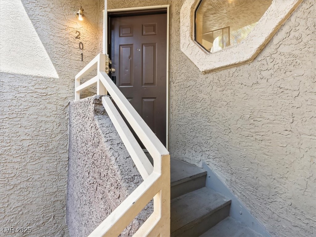 5052 South Rainbow Boulevard, Unit 201 Las Vegas, NV 89118 - Photo 2 of 24 Doorway to property with stucco siding