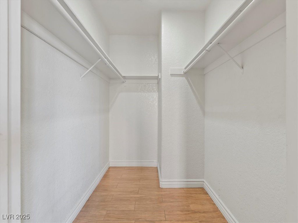 5052 South Rainbow Boulevard, Unit 201 Las Vegas, NV 89118 - Photo 22 of 24 Spacious closet with light wood finished floors