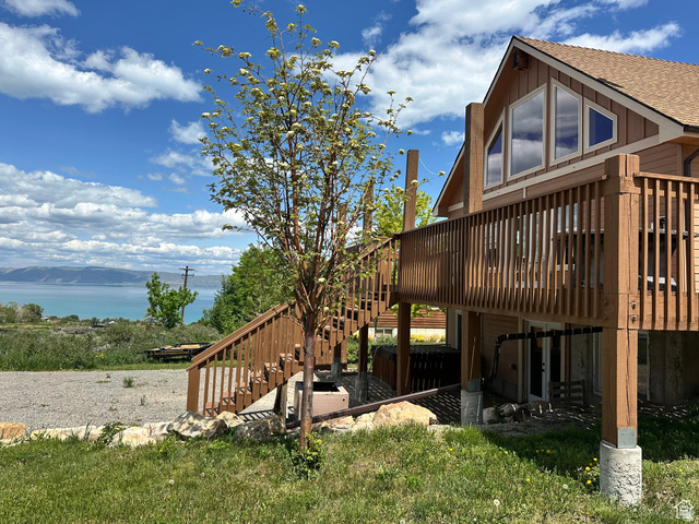 12 Crook Street Fish Haven, ID 83287 - Photo 7 of 35 View of side of home with a deck with mountain view, roof with shingles, board and batten siding, and a patio area