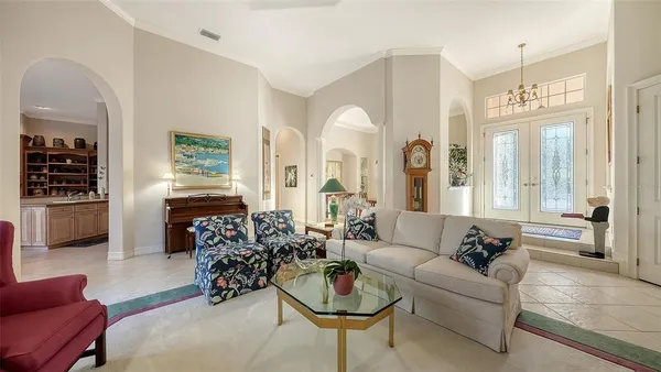 a view of a dining room with furniture and chandelier