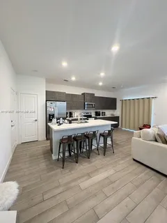 a kitchen with stainless steel appliances granite countertop a refrigerator and a stove