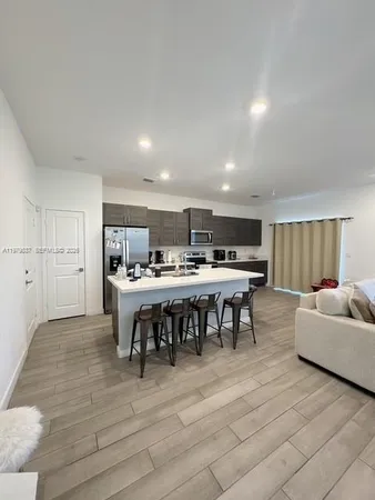a kitchen with stainless steel appliances granite countertop a refrigerator and a stove