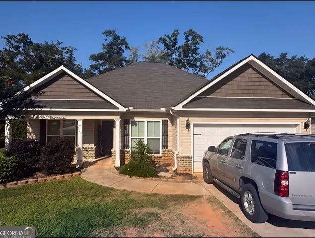 a front view of a house with garden