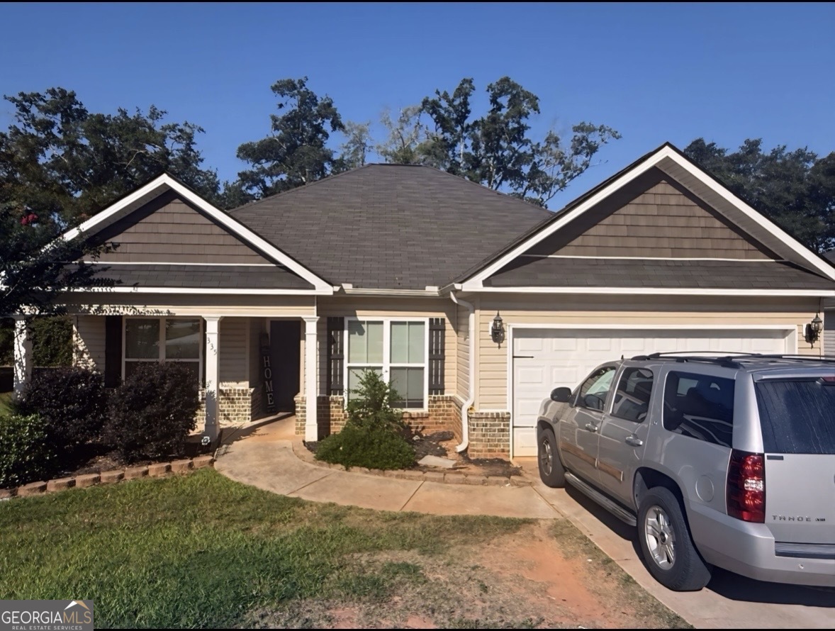 a front view of a house with garden