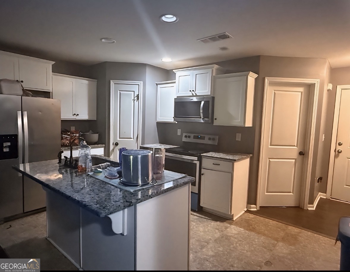 335 Stanebrook Court Jackson, GA 30233 - Photo 3 of 3 a kitchen with stainless steel appliances granite countertop a sink stove and refrigerator