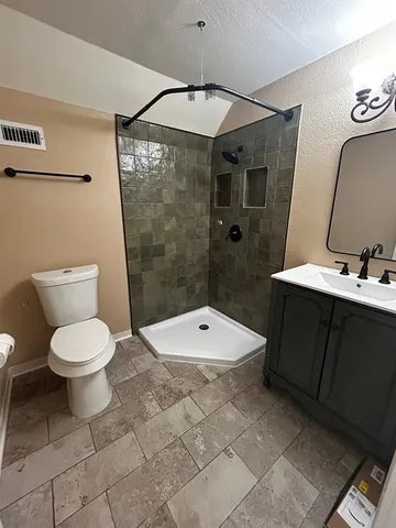 a bathroom with a toilet a sink and shower