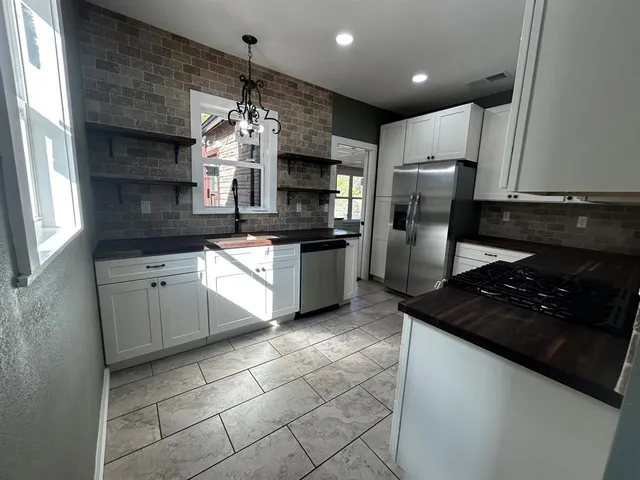 a kitchen with refrigerator and cabinets