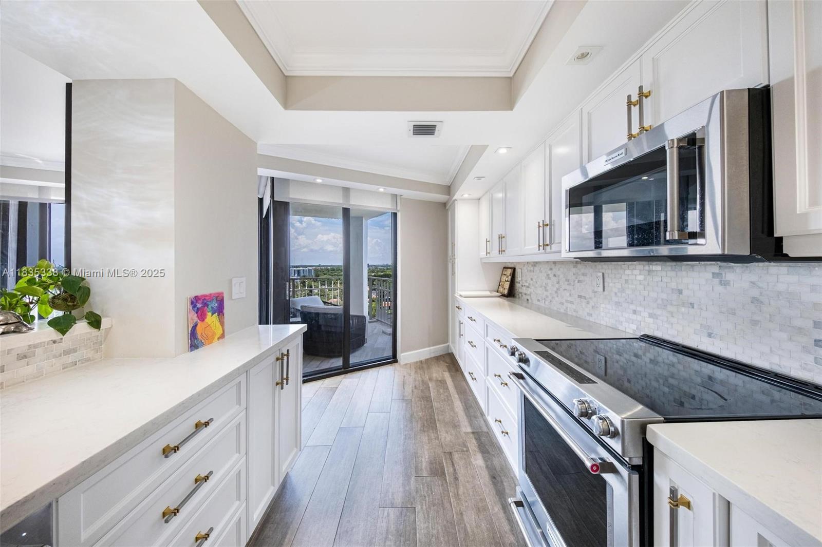 4000 Towerside Terrace, Unit 1507 Miami, FL 33138 - Photo 12 of 86 a kitchen with stainless steel appliances a sink dishwasher stove microwave and cabinets