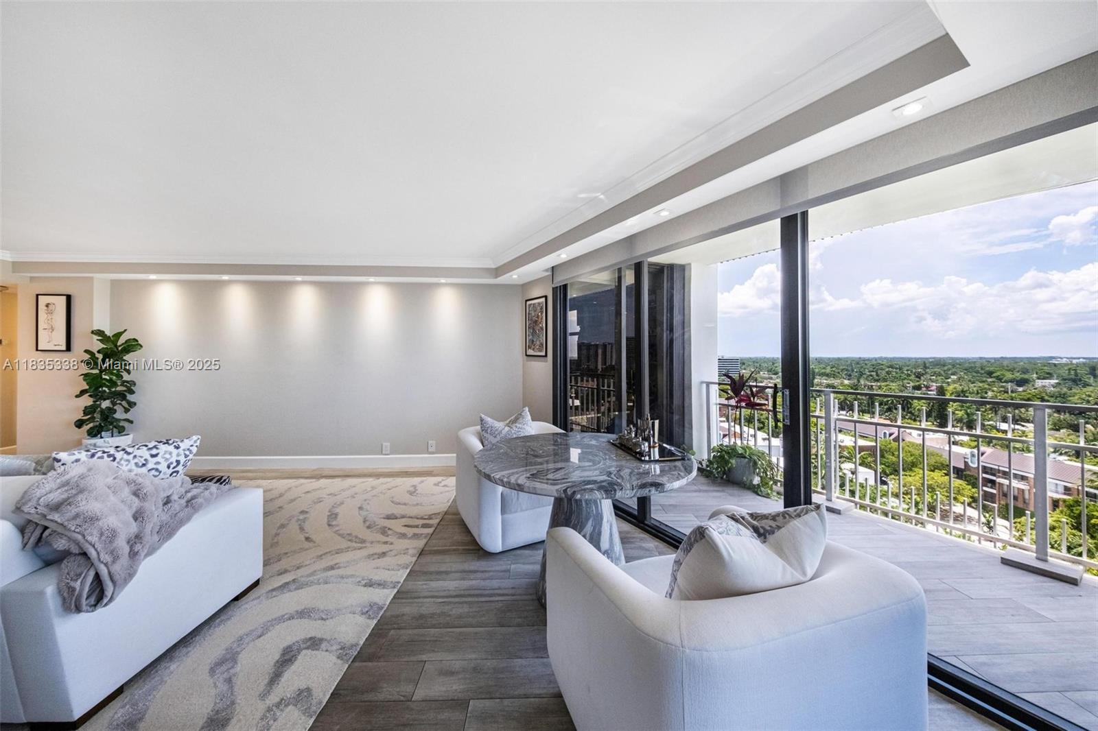 4000 Towerside Terrace, Unit 1507 Miami, FL 33138 - Photo 17 of 86 a living room with furniture and a floor to ceiling window