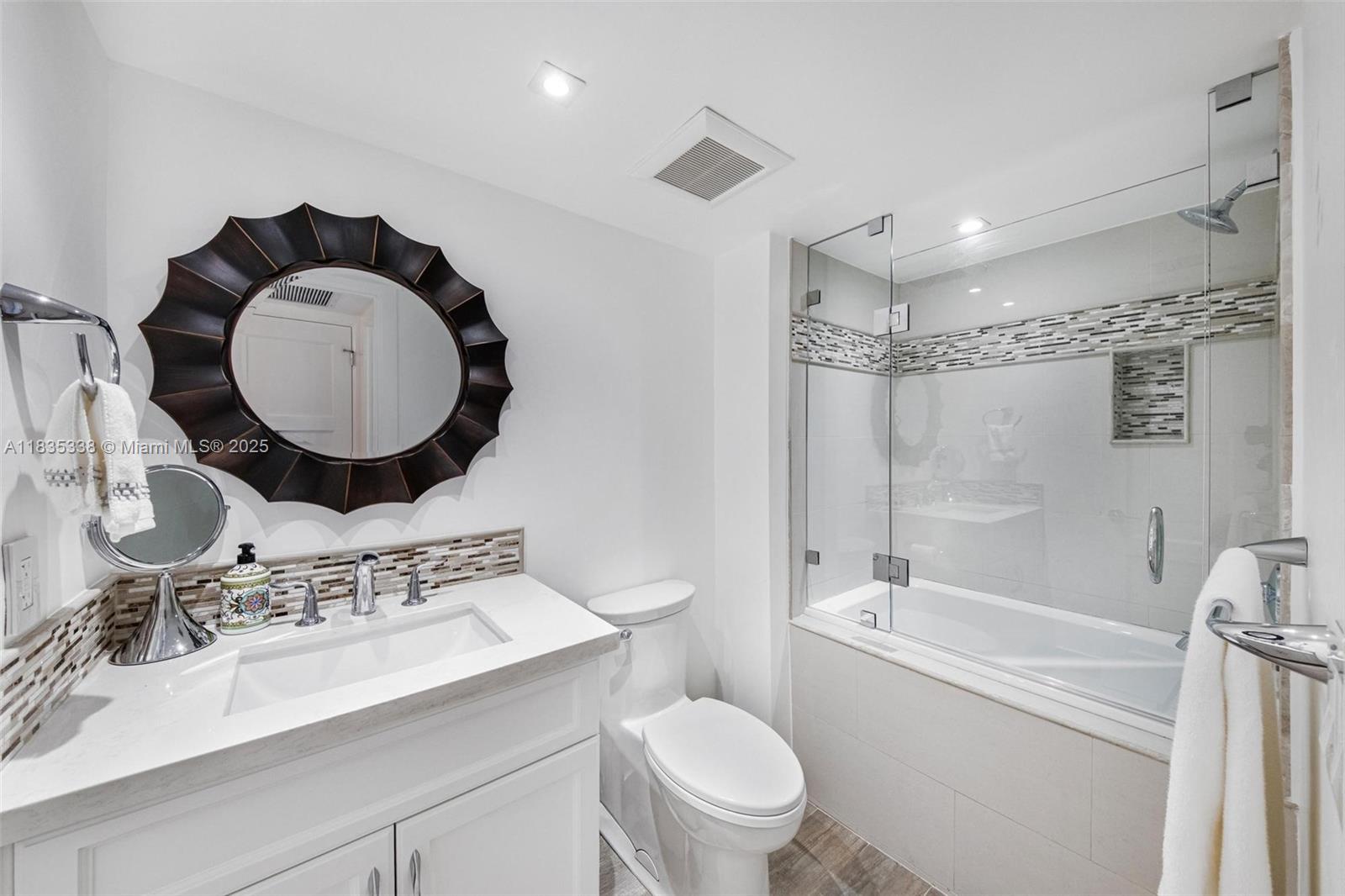 4000 Towerside Terrace, Unit 1507 Miami, FL 33138 - Photo 26 of 86 a bathroom with a sink toilet mirror vanity and shower