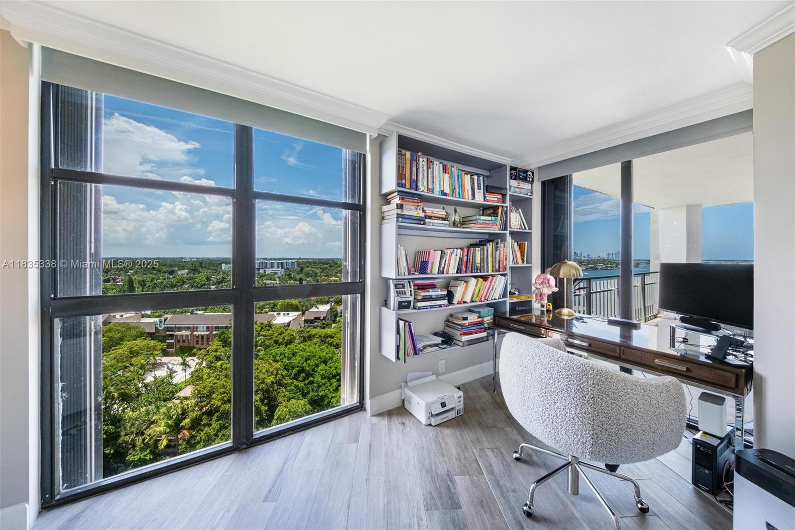 4000 Towerside Terrace, Unit 1507 Miami, FL 33138 - Photo 30 of 86 a living room with furniture a flat screen tv and a floor to ceiling window