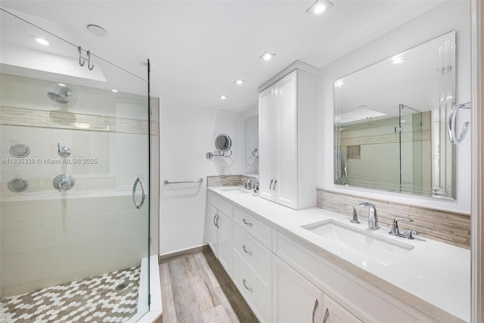 4000 Towerside Terrace, Unit 1507 Miami, FL 33138 - Photo 32 of 86 a bathroom with a double vanity sink a mirror and a shower