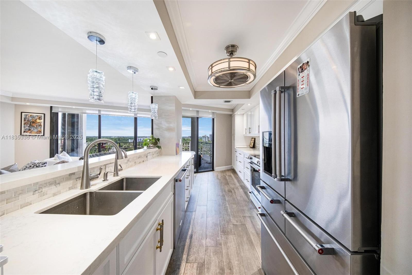 4000 Towerside Terrace, Unit 1507 Miami, FL 33138 - Photo 7 of 86 a kitchen with stainless steel appliances granite countertop a sink a stove and a refrigerator
