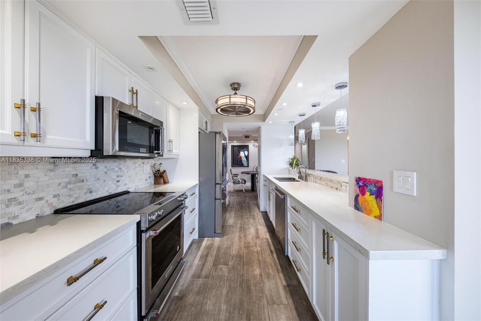 4000 Towerside Terrace, Unit 1507 Miami, FL 33138 - Photo 10 of 86 a kitchen with granite countertop lots of counter top space and stainless steel appliances