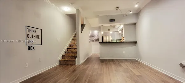 a view of kitchen appliances and wooden floor