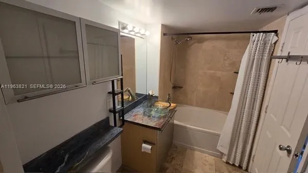 a kitchen with stainless steel appliances granite countertop a stove a microwave and a refrigerator